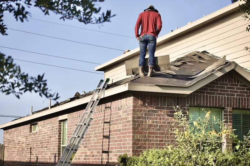 Professional roofer working on a residential roof in Higley Park